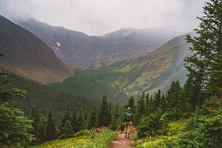 Man hiking in misty mountains