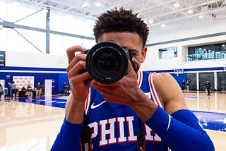 A basketball player on the court prepares to take a picture.
