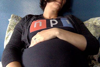 An NPR T-shirt stretched over my pregnant belly.