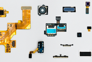 Blue and Yellow Phone Modules laid out on a light grey background
