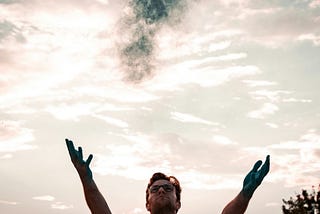 A man opening his arms to the sky.