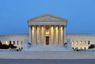 A panoramic photograph of the west facade of the Supreme Court of the United States building in Washington, DC, at dusk