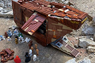 Star Wars Sand Crawler with a bunch of bricks and characters. Boba Fett fell over, and it’s meant to show a lot from a little