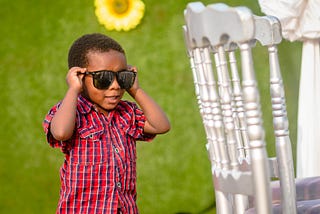 A two-year boy rocking a pair of oversized dark shades