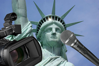 The Statue of Liberty with a microphone and camera in front of it