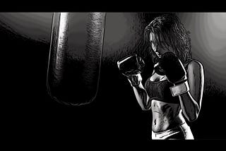 A woman wearing boxing gloves, a sports bra, and leggings, is ready to punch a heavy bag.