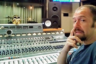 Hogan Torah sits infront of a sound board