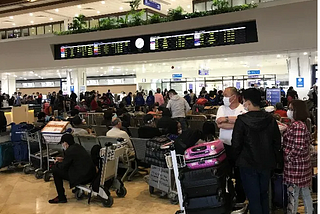 Travelers at Manila Ninoy Aquino International Airport anxiously await their flights home during the onset of the global Coronavirus pandemic. Photo by Brett Schmechel on March 17, 2020.