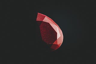 Close-up photograph of a ruby gemstone