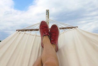 A man lying in a hammock, rising above the political turmoil that seems to be grabbing everyone by the throat. America. 2024 Election. Presidential Politics. Peace.