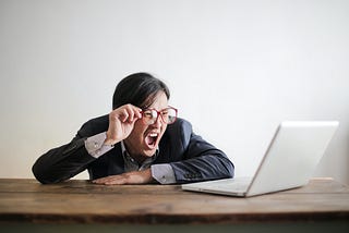 A person yelling at his laptop screen