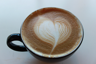 photo of a coffee with heart foam on top