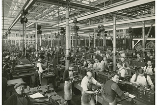 A factory floor from the early days at Ford where they standardized the production process through standardization and systems.