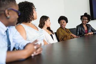 People sitting at desk. Diversity, equity, inclusion, philanthropy, supply chain, marketing, corporate social responsibility