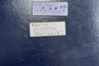 Label on a journal of songs, riating, and klues for mysteries all misspelled by a young scribe