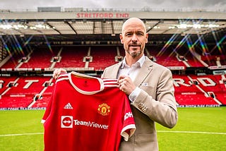 Erik ten hag holding Man UTD jersey at Old Traford