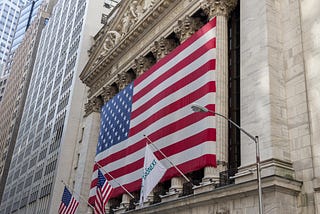 A photo of the New York Stock Exchange draped in an American flag