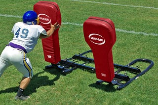 A Hard Head Meets a Blocking Sled