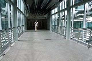 Man walking in hallway of empty office building