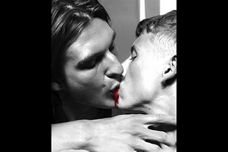 two men kissing, blood between their lips