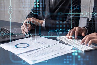 The image shows a professional setting where a person is engaged in analytical work. They appear to be a business professional, examining documents and data while working on a computer keyboard with a laptop open beside them. Overlaying this scene are digital graphics symbolizing data connections and network interactions, suggesting a focus on technology, data analysis, or cyber operations. The overall impression is one of modern business analysis or data management