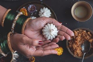 A lady showcasing a delicious steam modak.