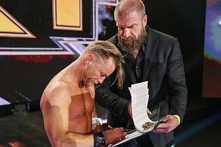 Drake Maverick signing an NXT contract with Triple H