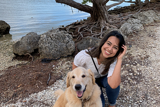 Angie and her golden retriever by the water.