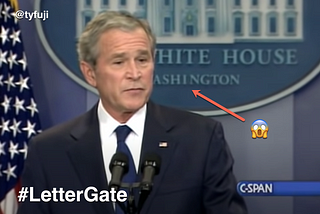President Bush stands in front of the White House lectern. Behind him is a sign with a design error.