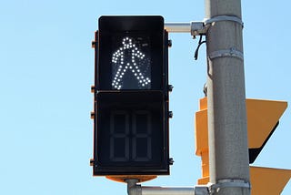 A traffic signal indicating “walk”.