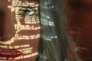code being shown on a female human face