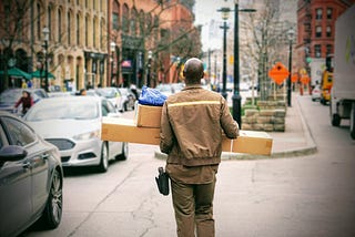 A delivery driver carrying parcels