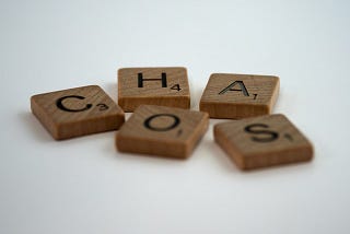 Scrabble tiles spelling the word ‘chaos’