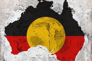 A picture of the continent of Australia with the Indigneous flag across it: black and red, with a yellow circle.