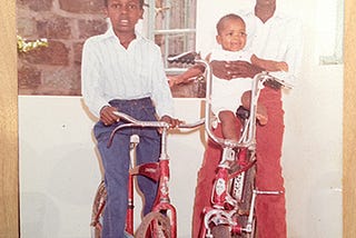 Photo of me and my brother with my younger sister sitting in his lap