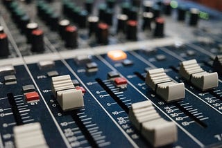 Closeup of slider knobs on an audio mixing desk.