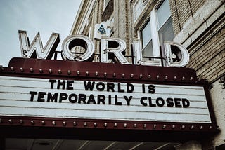 World Theatre sign that reads: The World is Temporarily Closed