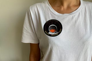 mission sticker on a white tee-shirt