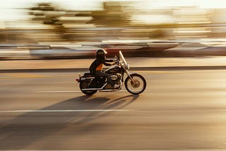 Time-lapse photography of a man riding a motorcycle