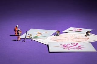 Images of flowers and a brain scattered on a purple background next to miniature figures dressed in high vis and helmets.