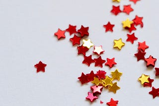 Selective-focus-photography of assorted red and gold cutout stars