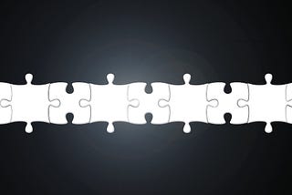 White puzzle pieces connecting together in a line