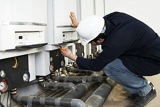 a commercial plumber doing maintenance.