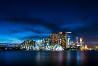 a dark sky over Singapore cityscape with lit iconic buildings