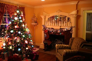 A Christmas tree fully decorated in a living room long past the holidays
