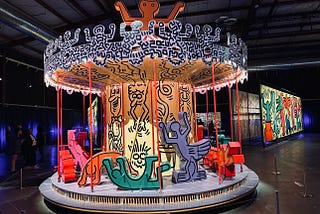 A carousel with figures by artist Keith Haring