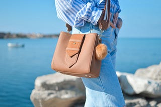 woman near a beach with a purse