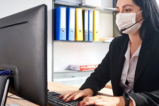 Return to the office- Female employee working on computer.