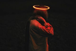 Ominous-looking woman under a right light, with a halo over her head.