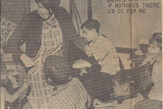 A young woman dances with children while a young man plays piano